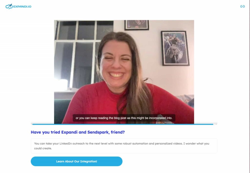 Personalized Sendspark test video with a woman engaged in a video chat, smiling as she communicates with someone on her screen.